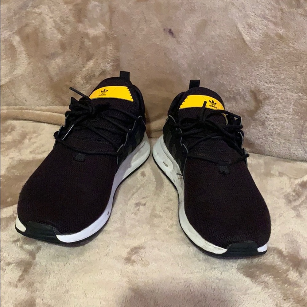 Black and yellow adidas shoes